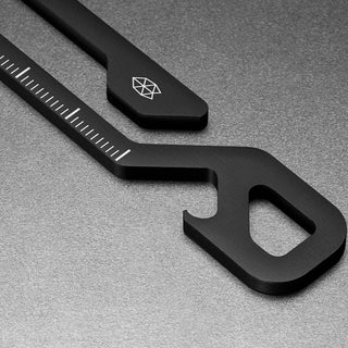 James The Rowan Multitool close-up showing black stainless steel with built-in ruler and bottle opener details