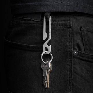 James The Rowan Multitool in stainless steel clipped to black jeans holding keys with visible ruler detail