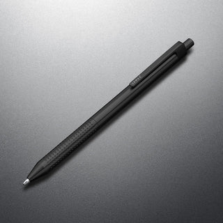 James The Burwell Ballpoint Pen in matte black, angled on a grey surface