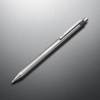 James The Burwell Ballpoint Pen in stainless steel, angled on grey