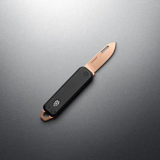 James The Elko Knife with black G10 handle and copper-toned Sandvik steel blade by The James Brand