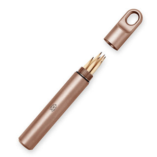 James The Randolph Capsule in bronze titanium with open cap showing wooden toothpicks inside compact container