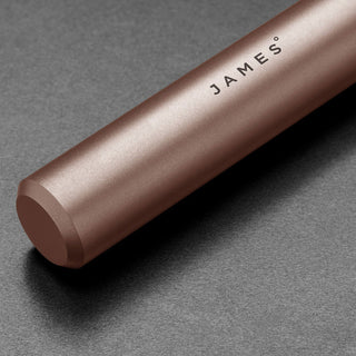 James The Randolph Capsule in matte titanium finish with engraved James branding on dark background