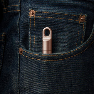 James The Randolph Capsule in bronze titanium fits neatly in a denim pocket with visible stitching details