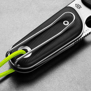 James The Redstone Knife close-up of black handle with stainless steel pocket clip and neon green lanyard