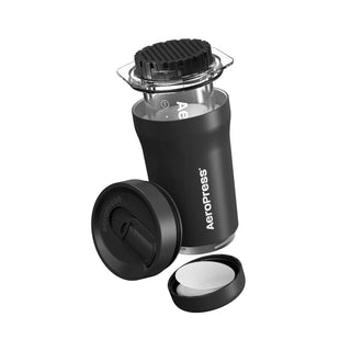 AeroPress Go Plus Travel System in black with plunger, filter cap, and brewing chamber displayed separately