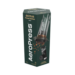 AeroPress Go Plus Travel System black coffee maker box with brewed coffee grounds pouring down