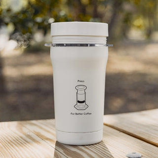 AeroPress Go Plus Travel System white compact coffee maker with simple press brewing instructions outdoors