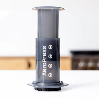 AeroPress Original Coffee Maker in clear plastic showing volume markings and plunger design