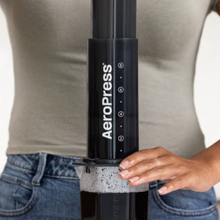 AeroPress XL Coffee Press in black medical-grade plastic being used to brew coffee by hand