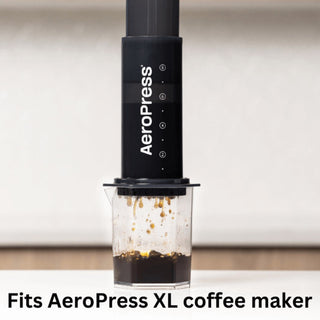 AeroPress XL Stainless Steel Reusable Filter attached to AeroPress brewing dark coffee into clear cup