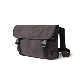 Bellroy Cinch Messenger Bag in dark recycled nylon with buckle closure and adjustable shoulder strap