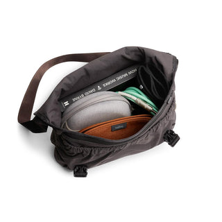 Bellroy Cinch Messenger Bag open showing organized contents and adjustable brown shoulder strap