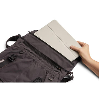 Bellroy Cinch Messenger Bag open showing padded compartment with tablet inside handled by person