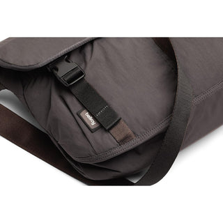 Bellroy Cinch Messenger Bag in dark fabric with adjustable strap and secure buckle closure detail