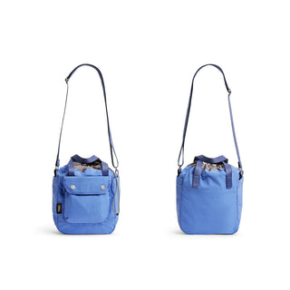 Bellroy Cinch Bucket Bag in blue recycled nylon with adjustable strap shown front and back views