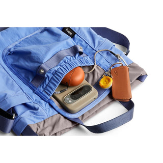 Bellroy Cinch Bucket Bag in blue with organized interior and leather key holder accessories