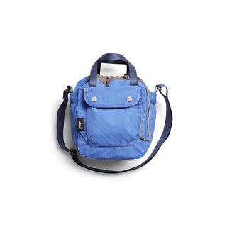 Bellroy Cinch Bucket Bag in blue recycled nylon with front flap pocket and adjustable strap