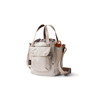 Bellroy Cinch Bucket Bag in light beige with front pocket and side bottle holder strap