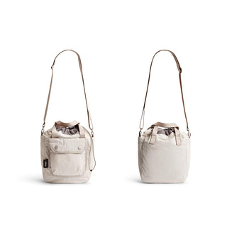 Bellroy Cinch Bucket Bag in beige recycled nylon showing front and back with adjustable strap