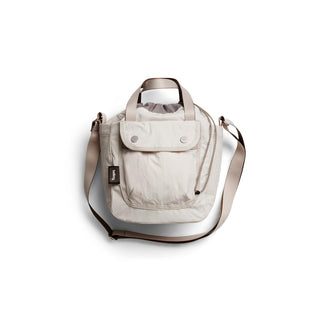 Bellroy Cinch Bucket Bag in light fabric with front pocket and adjustable shoulder strap detail