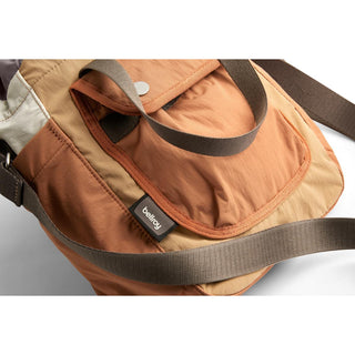 Bellroy Cinch Bucket Bag in earth tones with recycled nylon fabric and adjustable strap detail