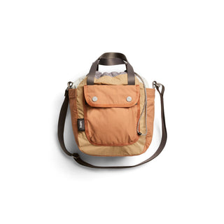 Bellroy Cinch Bucket Bag in tan recycled nylon with front pocket and adjustable shoulder strap