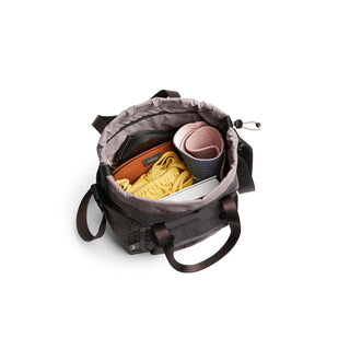 Bellroy Cinch Bucket Bag open, showing organized interior with yoga mat and essentials inside