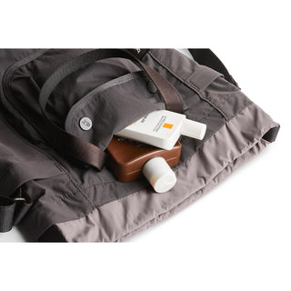 Bellroy Cinch Bucket Bag in dark gray fabric with adjustable shoulder strap and compact design