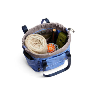 Bellroy Cinch Tote in blue showing spacious interior with rolled towel and daily essentials inside