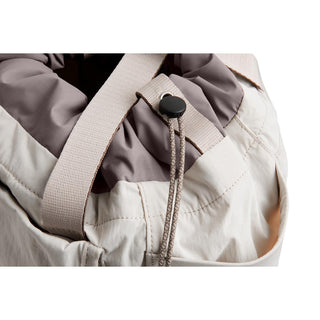 Bellroy Cinch Tote close-up of beige recycled nylon fabric with adjustable strap and cord lock detail