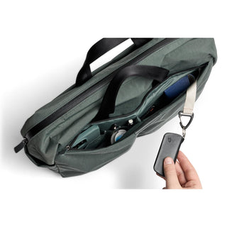 Bellroy Tokyo Work Bag in green with organized compartments and keyholder clip in use