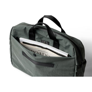Bellroy Tokyo Work Bag in green recycled fabric with front pocket holding magazines and sturdy handles