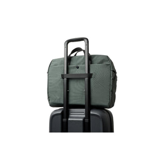 Bellroy Tokyo Work Bag in green attached to a black suitcase handle with durable fabric details