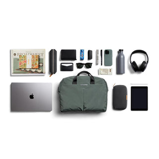 Bellroy Tokyo Work Bag in green with organized daily essentials and tech accessories laid out flat