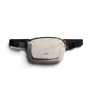 Bellroy Lite Belt Bag in light beige recycled fabric with adjustable black strap and compact design