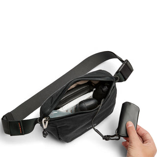 Bellroy Lite Belt Bag in black recycled nylon with adjustable strap and interior compartments visible