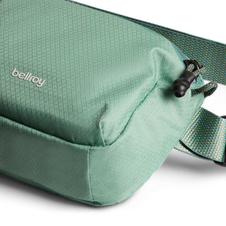 Bellroy Lite Belt Bag in green recycled nylon with textured fabric and adjustable strap detail