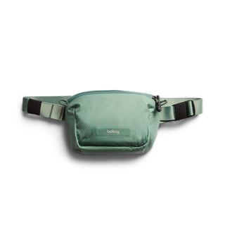 Bellroy Lite Belt Bag in muted green recycled nylon fabric with adjustable strap and zipper closure
