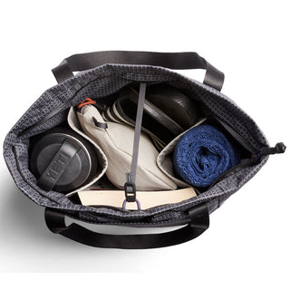 Bellroy Lite Totepack showing organized interior with shoes, towel, water bottle, and strap closure