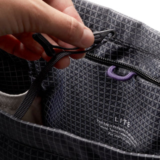 Bellroy Lite Totepack black recycled fabric close-up showing zipper pull and interior pocket details