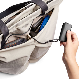 Bellroy Lite Totepack in beige showing organized interior and attached key fob close-up view