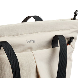 Bellroy Lite Totepack in light fabric with black straps and minimalist logo detail close-up