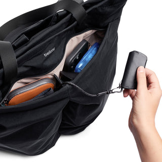Bellroy Lite Totepack in black showing organized interior pockets and detachable key holder clasp