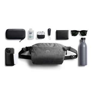 Bellroy Lite Sling in gray with adjustable straps and water-resistant recycled material shown with accessories