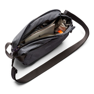 Bellroy Lite Sling Mini in dark gray with water-resistant fabric and organized zippered compartments