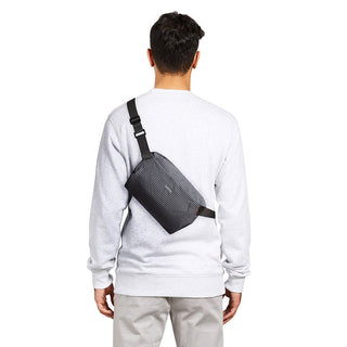 Bellroy Lite Sling Mini worn crossbody with water-resistant recycled fabric and textured black finish