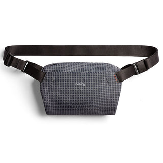 Bellroy Lite Sling Mini in dark grid-patterned fabric with adjustable black strap and compact design