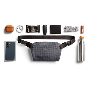 Bellroy Lite Sling Mini crossbody bag in textured grey fabric with adjustable black strap and compact design