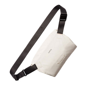 Bellroy Lite Sling Mini in off-white water-resistant fabric with adjustable black strap and zipper closure